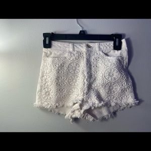 White denim shorts with floral detailing